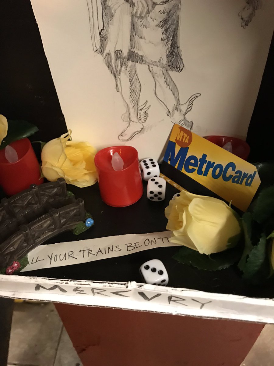 russ_owl's tweet photo. Was thinking that I really need the train to come quickly and then saw that someone has installed a little cardboard shrine to Mercury, god of transit (?) in my subway station https://t.co/8erYhg9kKE