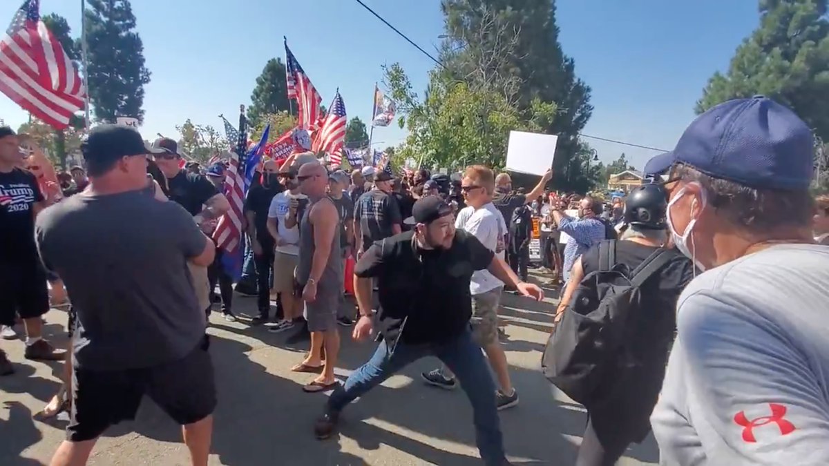 Helmet Lady tried to calmly walk away, but Blocker is FAR more physically fit that he appears.He's actually all muscle; look at his forearms. He knows she must pay a price for trying to escalate.On the left, NOBODY is escalating. VERY disciplined people.