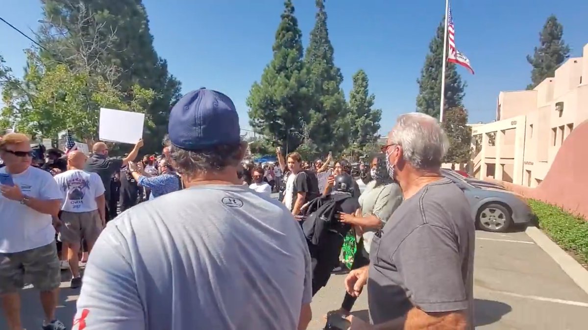 Helmet Lady tried to calmly walk away, but Blocker is FAR more physically fit that he appears.He's actually all muscle; look at his forearms. He knows she must pay a price for trying to escalate.On the left, NOBODY is escalating. VERY disciplined people.