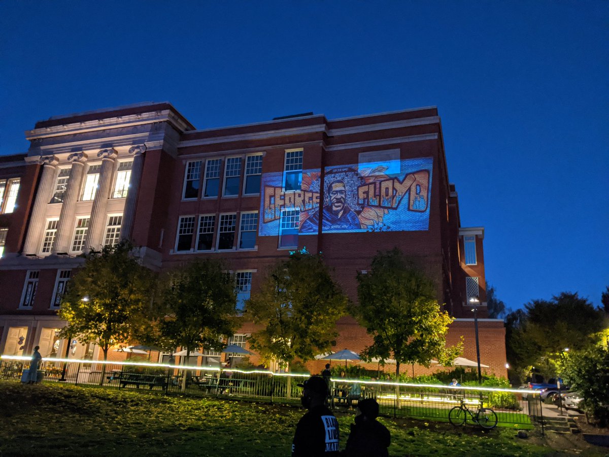 A projection against Revolution Hall as the sky grows dark