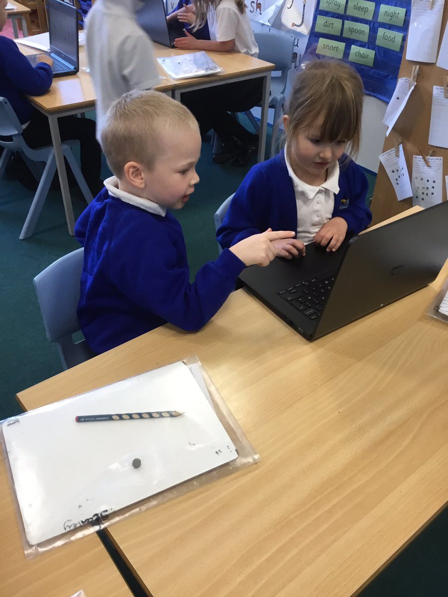 Working together to use the laptops.