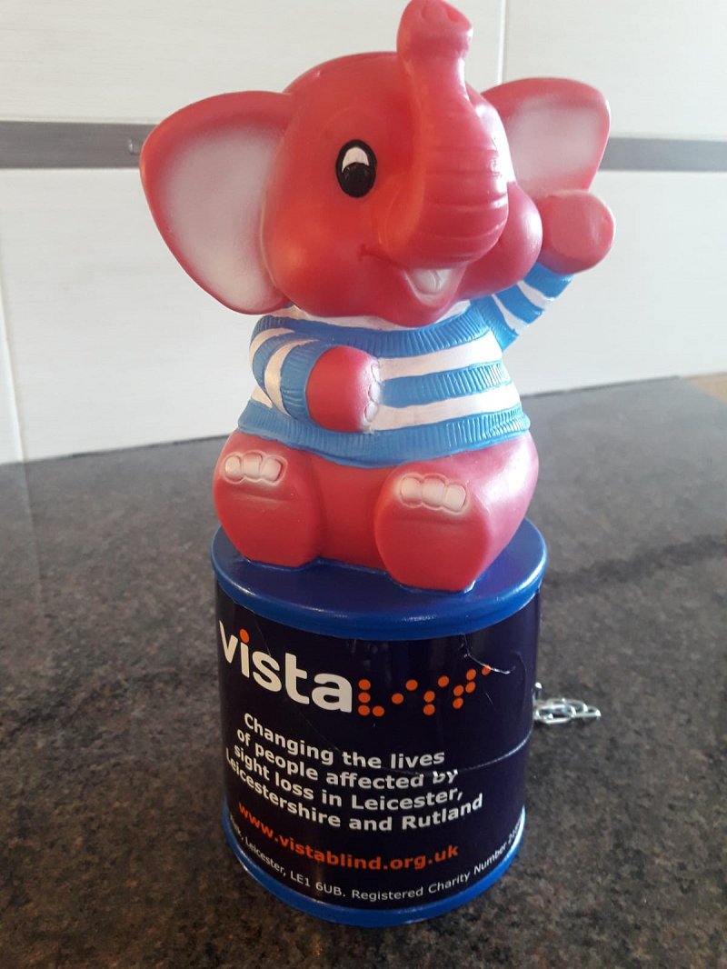 Pink elephant collection box with Vista logo on it.