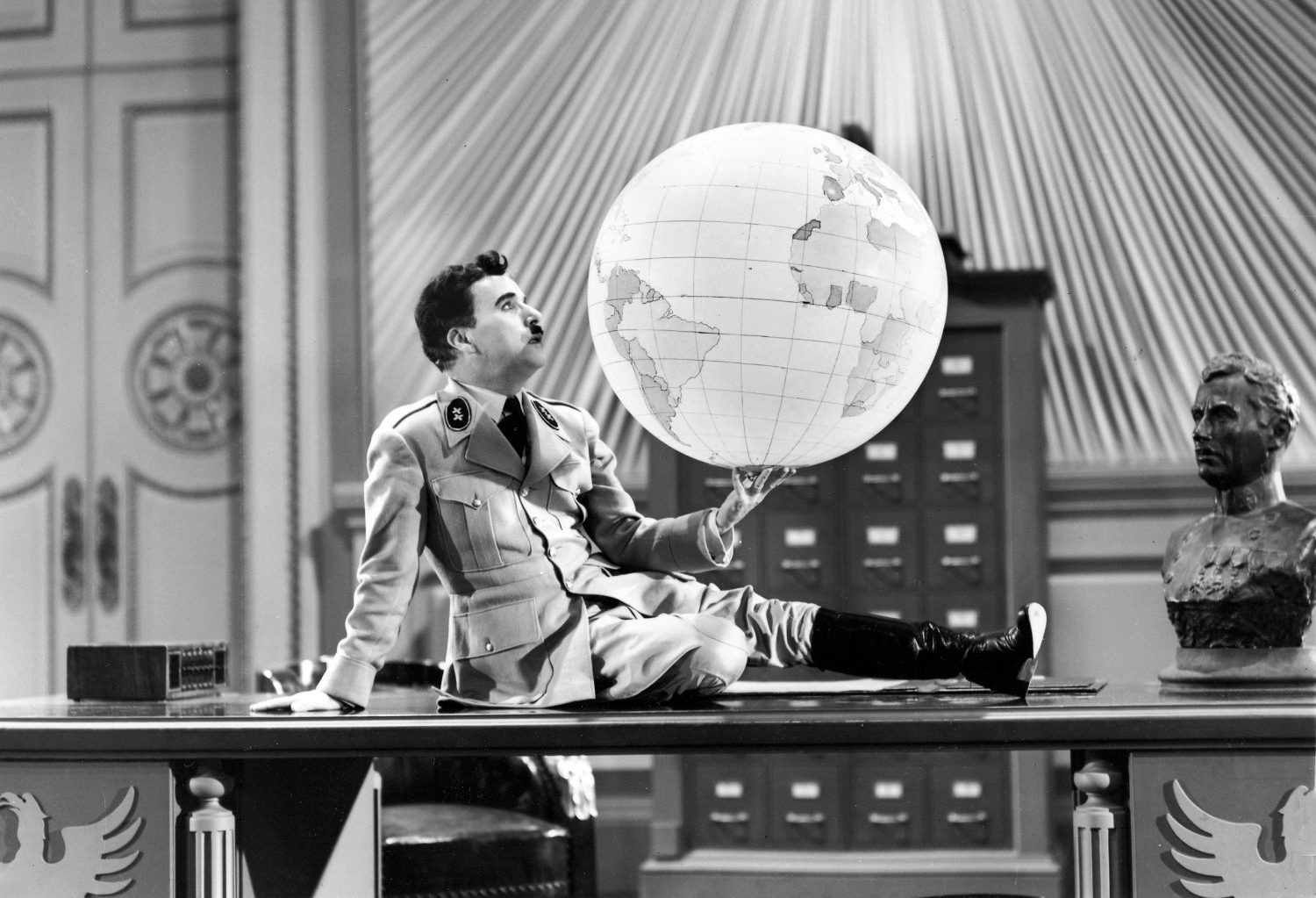Charlie Chaplin as “Adenoid Hynkel” holding a globe in a scene from The Great Dictator (1940).