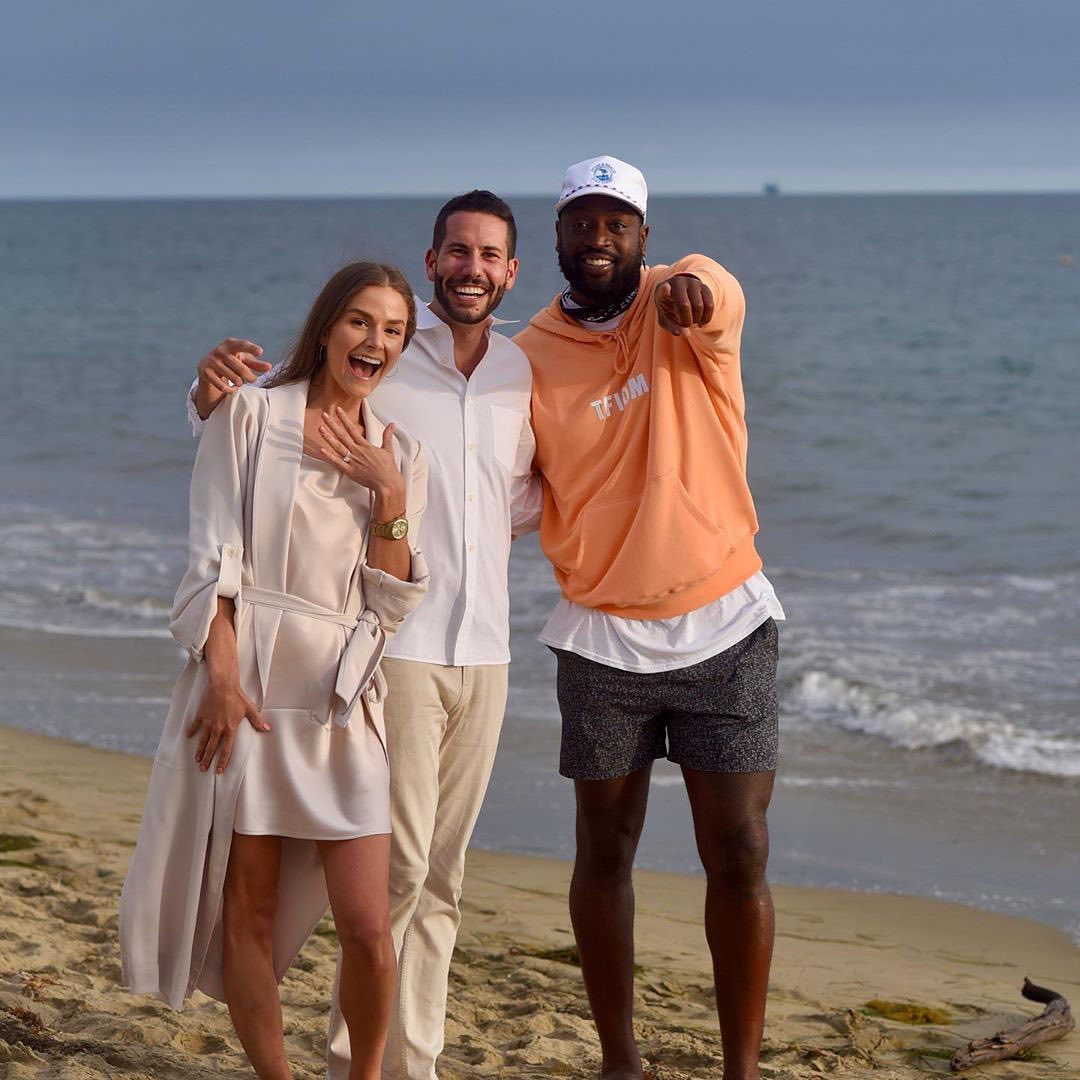 enews's tweet photo. A moment this couple, and Dwyane Wade, will never forget: "When @dwyanewade happens to be taking a sunset stroll on the beach and walks by mid-proposal 😂" (📷: IG/ryanbasch) https://t.co/SRusTzgkCY