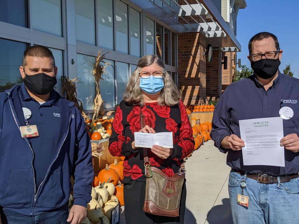Val Frick, representing the Camden City  Garden Club &amp; Camden Children's Garden, receives a generous Sprouts Farm Market foundation grant.  Val is flanked by Sprouts Farm Market manager Frank Pickel (right) and assistant manager Bob Gappa (left).  Thank you Sprouts!