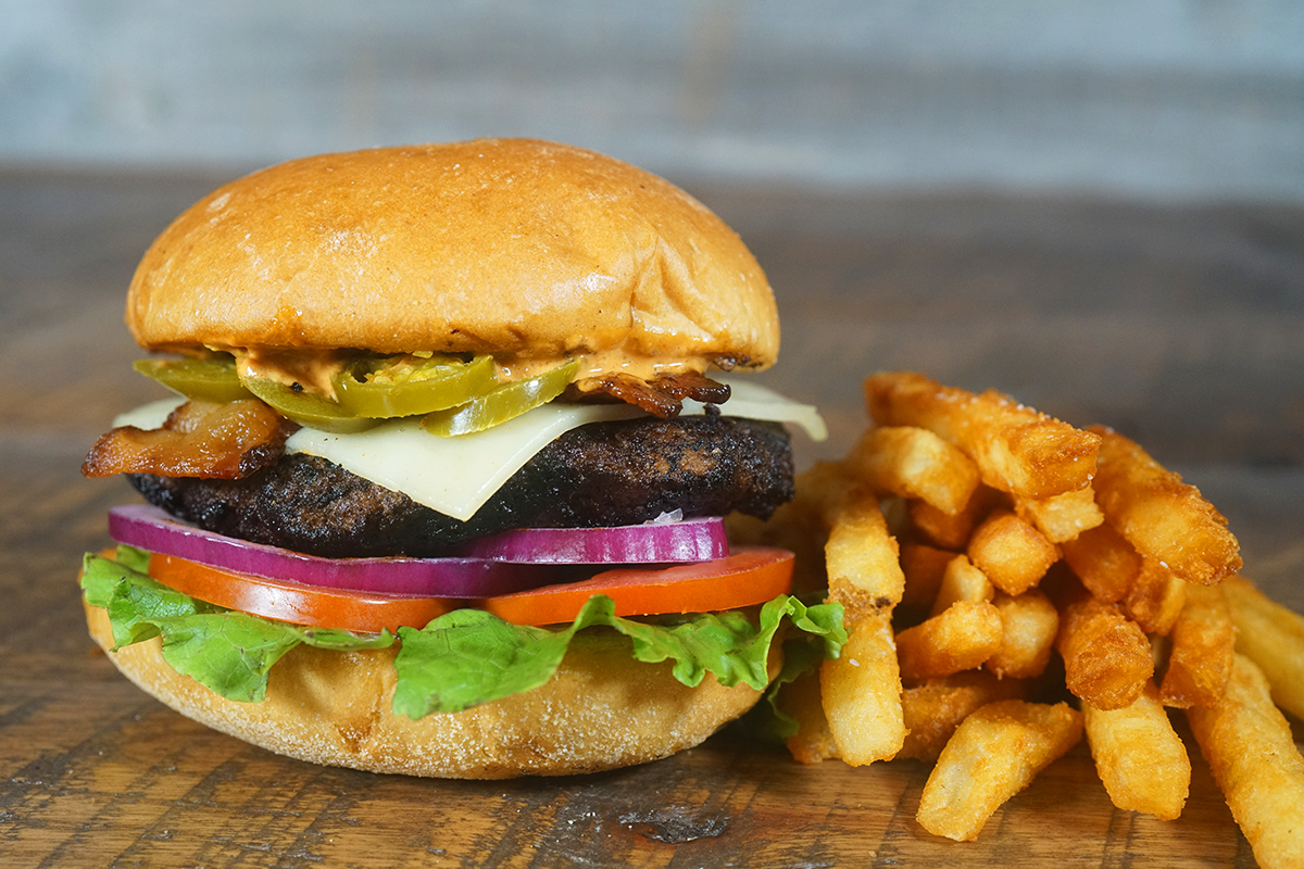 Enjoy our limited-time OOGIE BOOGIE'S NIGHTMARE BURGER - Grilled all beef patty with smoked bacon, pepper jack cheese, pickled jalapeños, Sriracha rémoulade on a brioche bun. This weekend only! Pairs perfectly with THE NIGHTMARE BEFORE CHRISTMAS now showing at Flix!