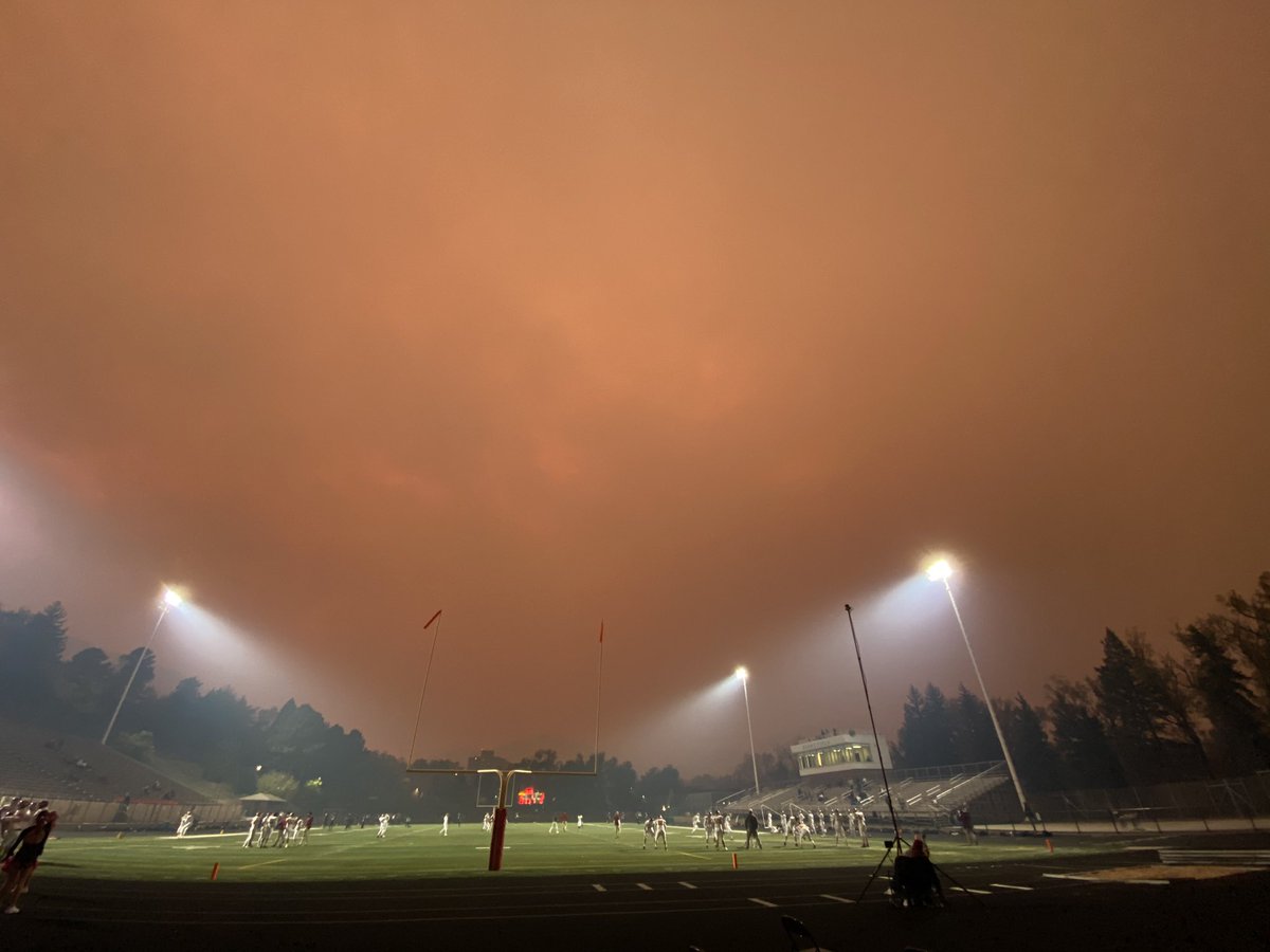 mitchellbyars's tweet image. This is the scene at #Boulder High, where they are apparently playing football despite the fact that tonight's Friday Night Lights are provided by the sun trying to penetrate falling ash (pic via @photojmatthew)