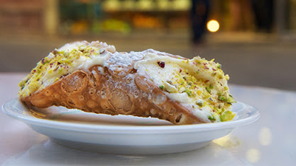 Naturally, I *must* start with the king of Sicilian pastry: cannolo. Filled with ricotta cream and topped with Bronte pistachio, candied fruit, or chocolate chips, cannoli come in different sizes and are a staple of Sicilian pasticcerie. 2/