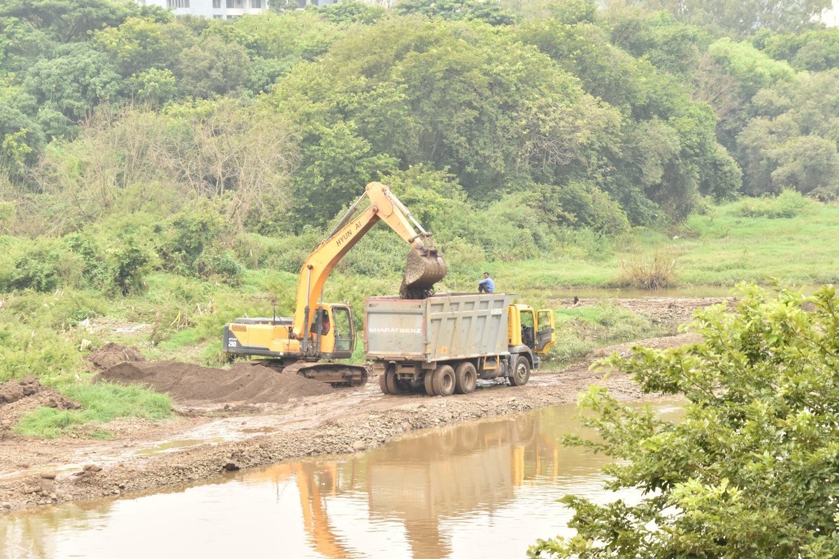 Soil theft at confluence of Ram Nadi and Mula River in Baner. Spotted an excavator and a truck operating from a blue shed crossing over Ram Nadi trampling vegetation, disturbing birds and stealing river bank soil in broad daylight. Locals said it has been going on for 2 weeks.