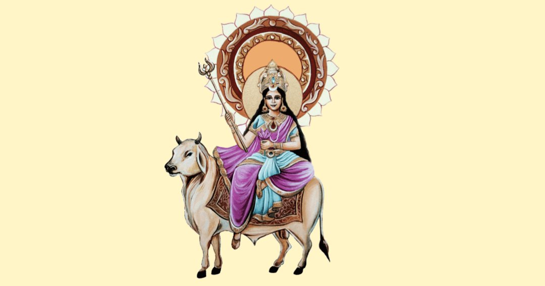 With her forehead adorned by Chandra and her hands holding the Trishula and Kamala, she is the personification of serenity, riding the Vrishabha.