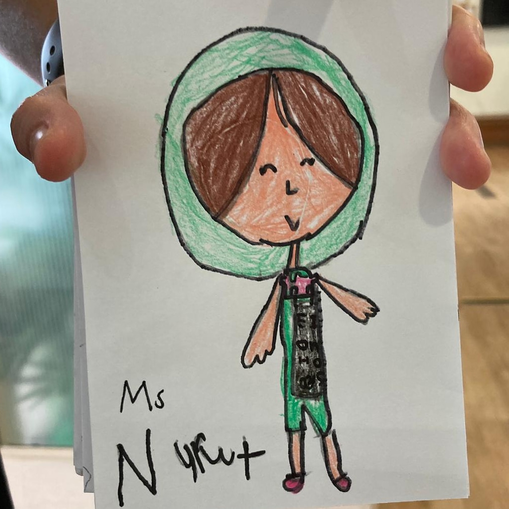 RozNuly's tweet photo. My ex student graduating Kindergarten this year, whom I worked with 5 years ago drew a picture of me. This is how she remembered me- in my pastel green scarf. 🥰🥰🥰 https://t.co/ly2oj37EXr