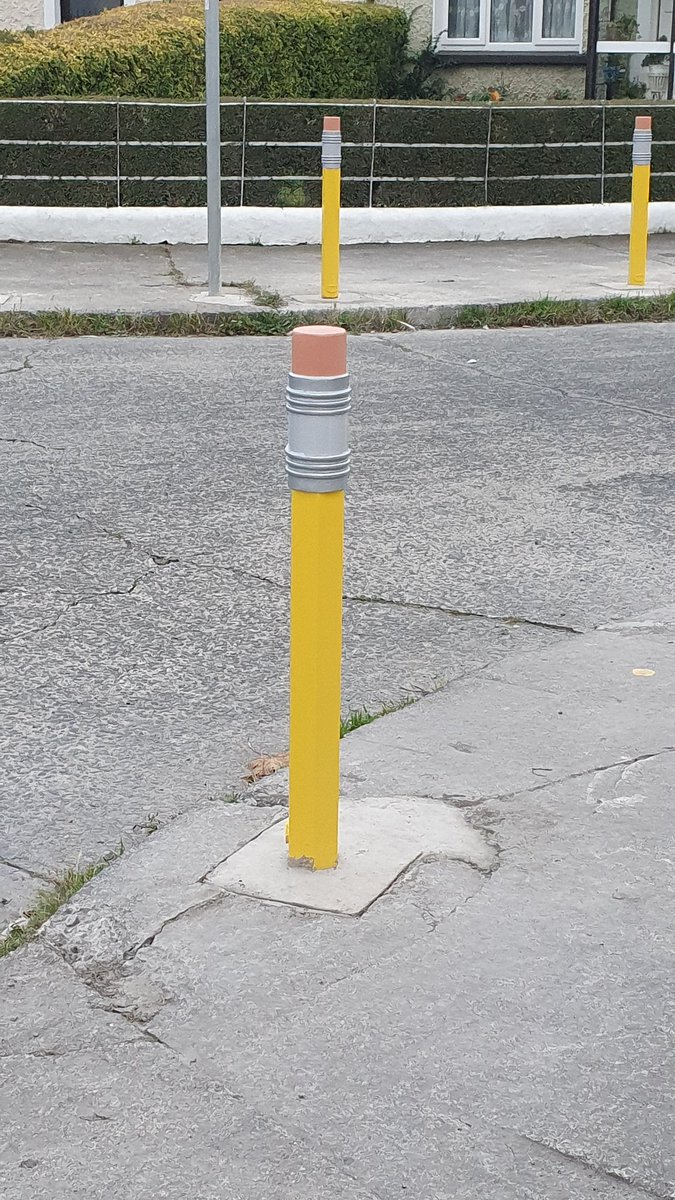 BrianCrowley75's tweet photo. Loving the pencil-inspired bollards outside Scoil Íosagán on Aughavannah Road just off Parnell Rd. Health and safety can also sometimes be fun it seems! I was also reminded of @MajekJess's fascinating study of the bollards of Thomas Street #whataloadofbollards @lisa_g_dub https://t.co/6YRh1d033r