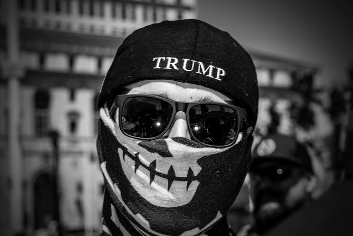A Proud Boy covers his face at San Francisco’s Demand Free Speech rally