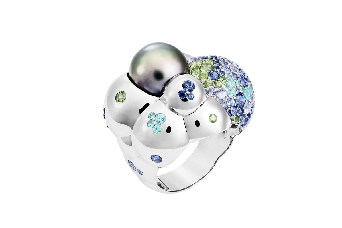 From Baumer, gotta be some sapphires in there. I think it's titanium or white gold? Possibly enameled. With a black pearl. One of the most creative pearl ring settings I've ever seen. And they matched the stones to the pearl's nacre.