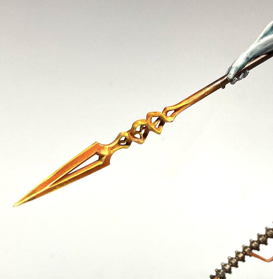the transforming spear is a great idea, representing the reality bending powers of the C’tan, I wanted to link mine to my army by having it change plain metal jnto the same kind of energy blade that my melee units have. Lucky orange is an easy glaze!
