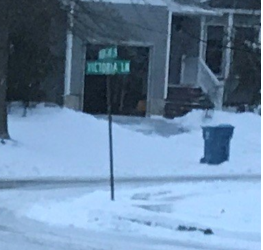 15/ Hacker voice: Computer, enhance.We see a sign for a cross street. The top sign is illegible, but the bottom reads “VICTORIA LN.”