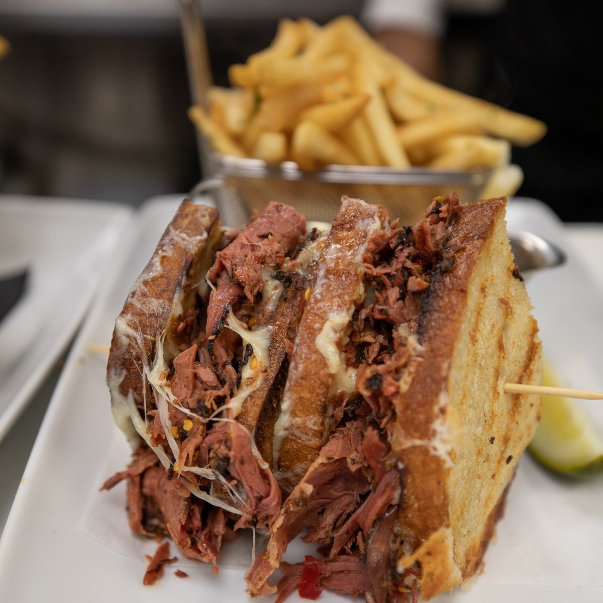 Bohlsen_Group's tweet photo. A big sandwich for the big day tomorrow. The "new " Old World Pastrami Sandwich from #Tellers... thick slices of house cured pastrami smothered in gruyere cheese, calabrian chili and stone ground mustard on toasted country bread.  Yea. And our famous fries. 

 #Foodie https://t.co/3FhABKFtPw