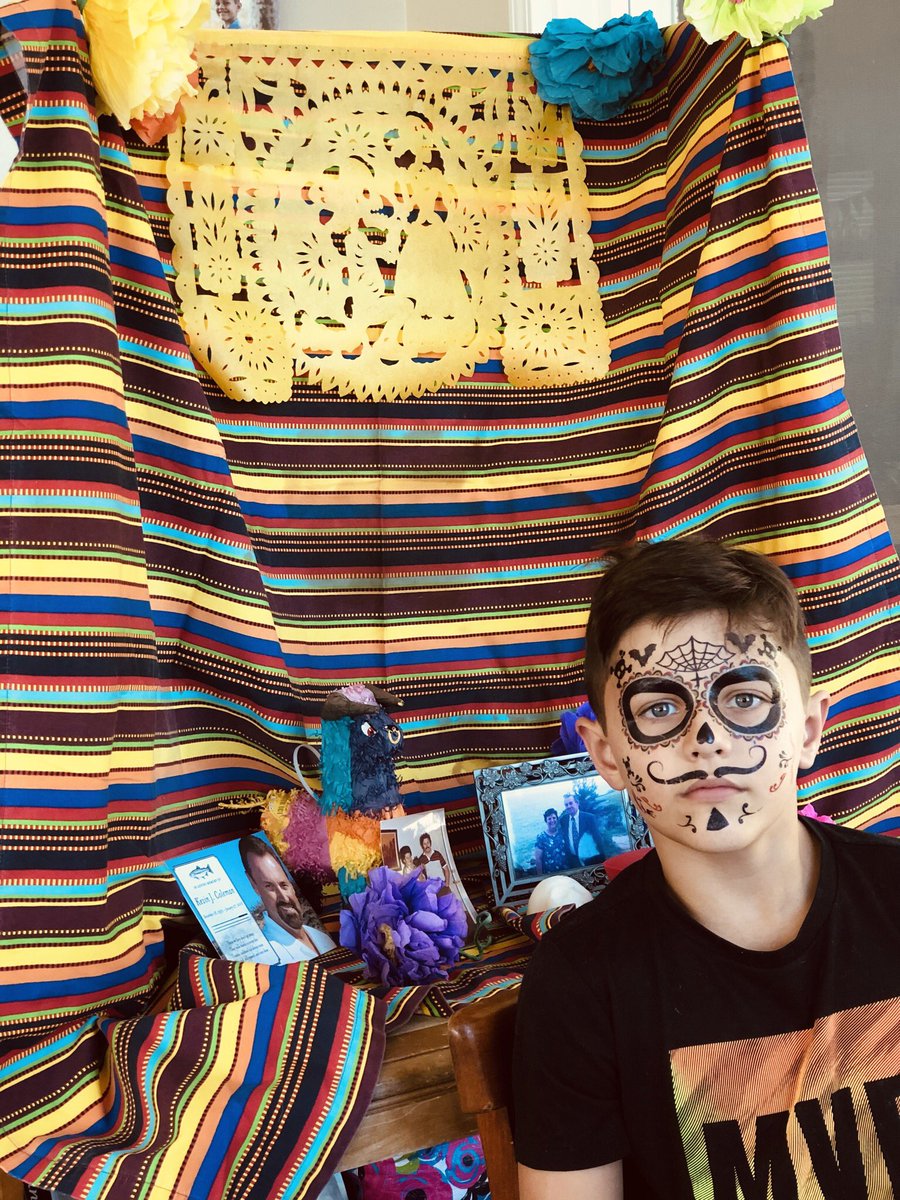 KarisCC's tweet photo. Liam’s class is celebrating Dia de los Muertos (even online) so he built an ofrenda for his background today and asked me to decorate his face. His teacher @BVsMsHa sent home a sugar skull and Pan de Muerto.  #TeachersareAmazing https://t.co/6pyG53Xa97