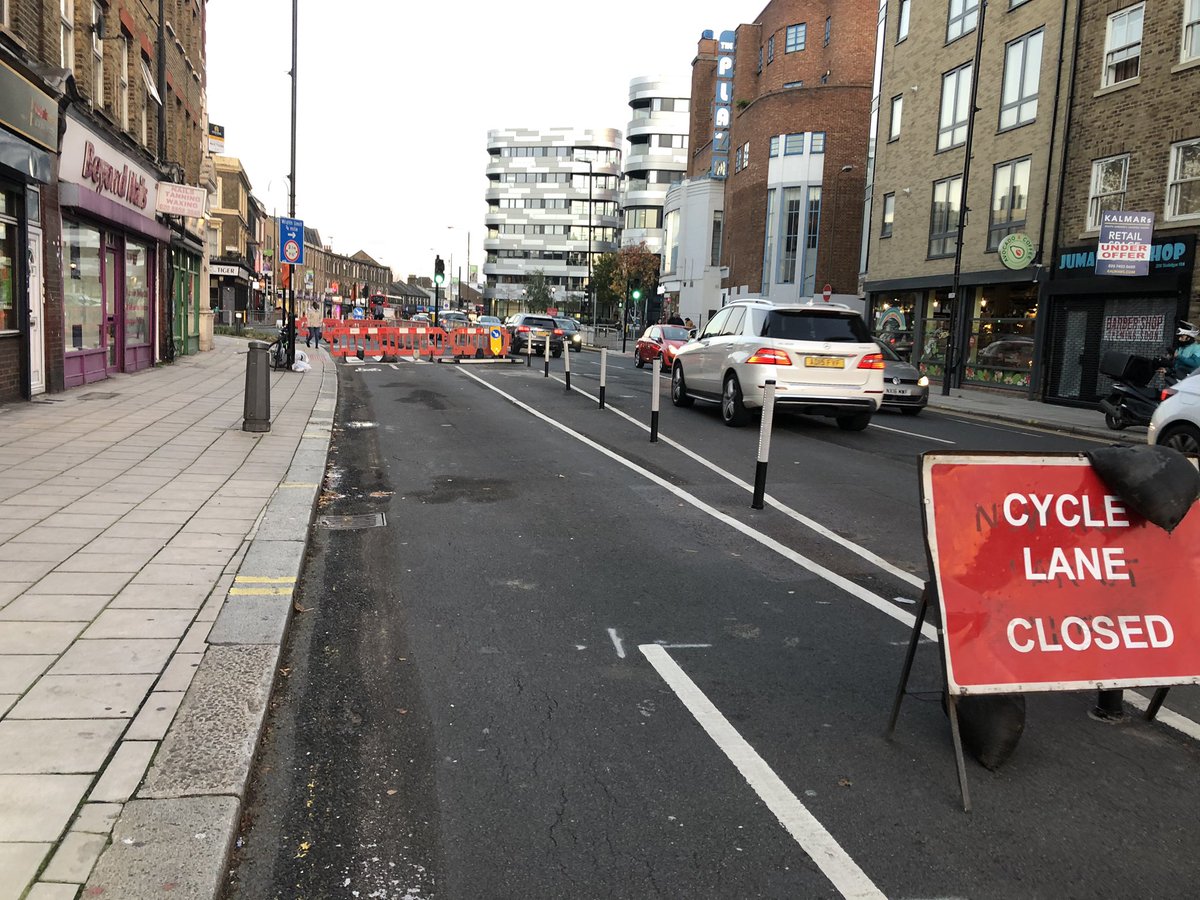 You then approach the busy Blackwall Lane junction. There’s a traffic light controlled filter lane for bikes but not yet operational. At least someone’s been down there and reinstated the temp barriers (pic left: last week, pic right: today)