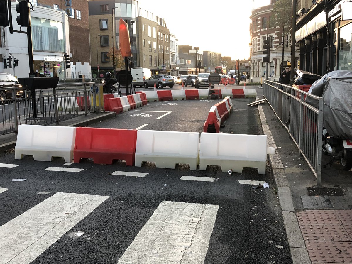 Work on the opposite side of the Blackwall Lane junction seem to have ground to a halt. Plans involve removing the barriers outside the pub and widening the pavement for pedestrians. No progress here recently, apart from reinstating the temporary barriers.