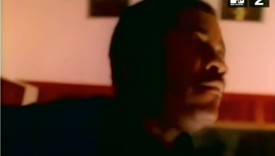 he's actually in the video, but if you blink you'll miss it.