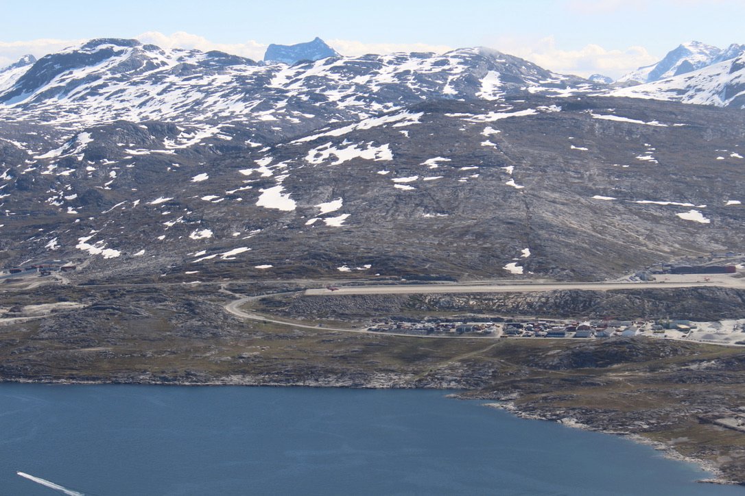 Welcome to Nuuk, Greenland! The clouds lift just in time for a visual landing. The Dash-8 on the runway gives a sense of the dimensions.