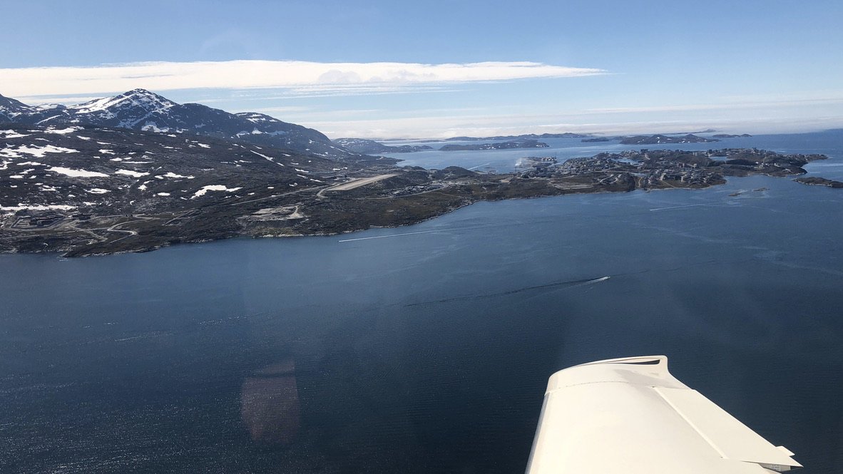 Welcome to Nuuk, Greenland! The clouds lift just in time for a visual landing. The Dash-8 on the runway gives a sense of the dimensions.