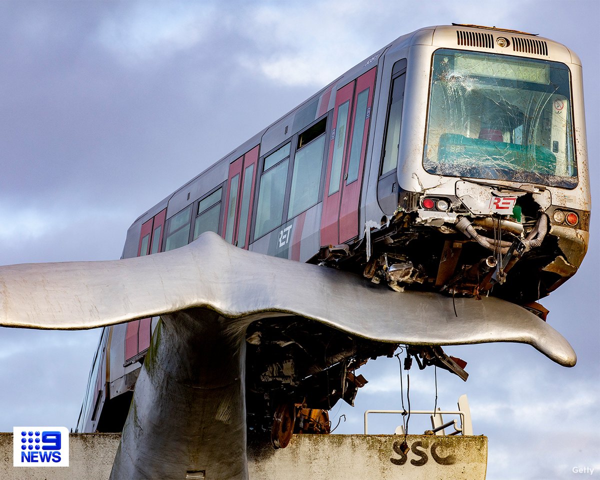 9NewsSyd's tweet photo. What a fluke – a sculpture of a whale’s tail has caught a train after it crashed through barriers in the Dutch city of Rotterdam. #9News 

Read More: https://t.co/wJabm1larV https://t.co/k3OiMh0lLy