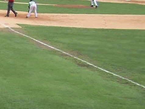 baawein's tweet photo. This picture from 10 years ago shows what happens when players warm up on foul line every game. Since this time our players have been asked to stand 4-5 feet inside line when warming up. Their estimates of what 4-5 feet vary enough to allow the grass to hang in there all summer. https://t.co/eRslePereF