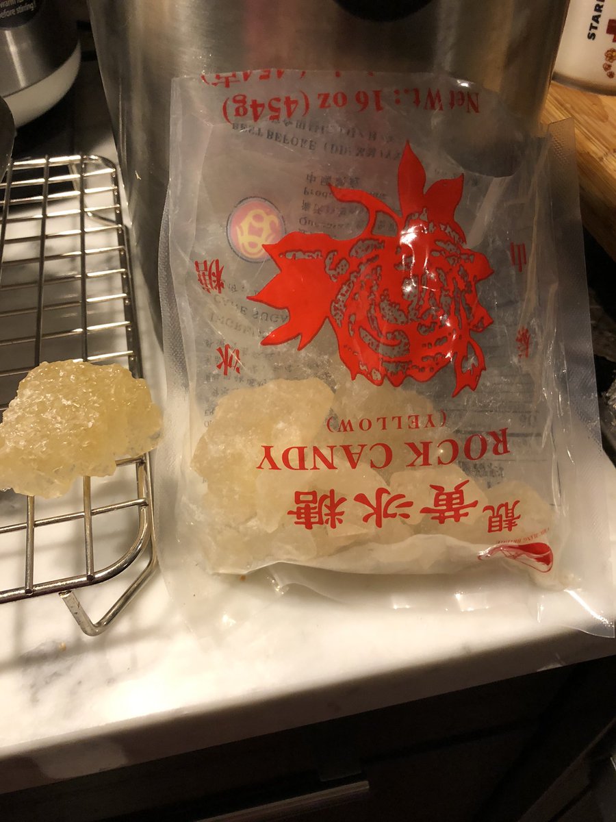 Last steps: squeezed the remaining milk from the cloth which is sitting over a fine mesh strainer. Added a few chunks of rock sugar, not processed white sugar. When I asked how much, mom just gave me A LOOK Should have known better 