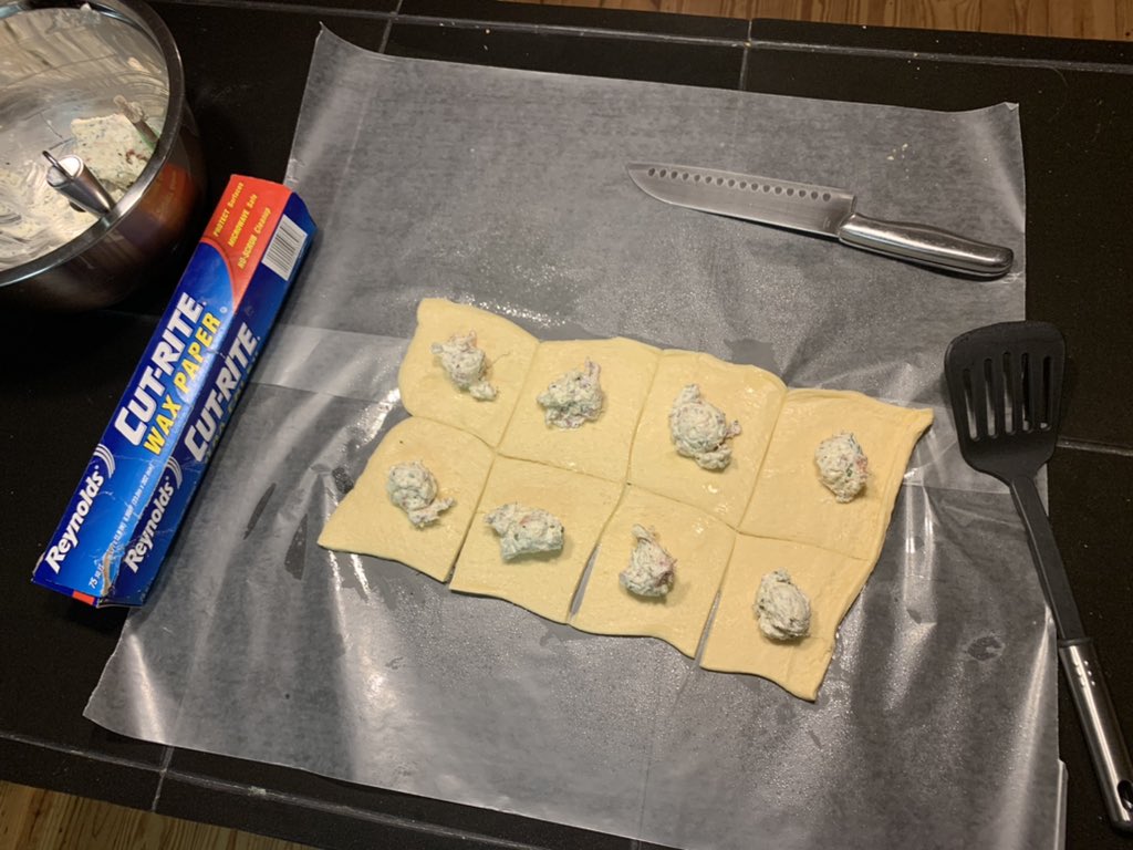 SassFromScratch's tweet photo. Cut the dough into 8 squares with a sharp knife sprayed with cooking spray. Place a heaping tablespoon of the filling on each square. I like to use my cookie dough scoop for this step. Then fold the corners into the center pressing gently to spread the filling out. https://t.co/JlEQQsOoMW