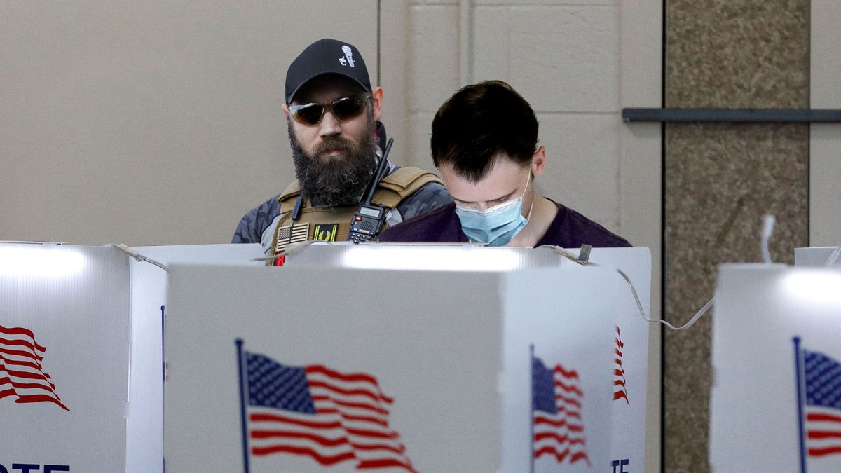 TheOnion's tweet photo. ‘Poll Watching Is Not Voter Intimidation,’ Trump Supporter Whispers Into Ear Of Man Filling Out Ballot In Voting Booth https://t.co/aO4QLjlNZA https://t.co/mEq4e3NRc0