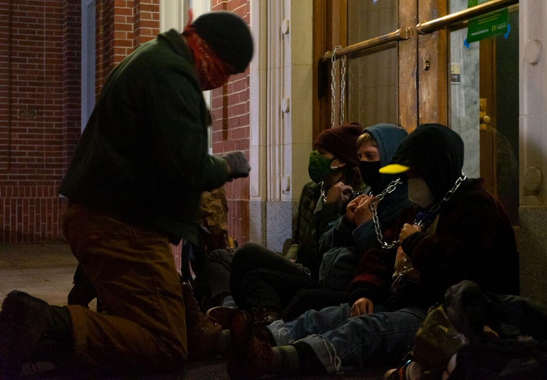 ODEphoto's tweet photo. ICYMI: Three protestors are chained to the north entrance of Johnson Hall as part of an overnight demonstration after a Black Lives Matter benefit concert on Oct. 4, 2020. // Photos by @summersurgentg https://t.co/9dytN7CobP