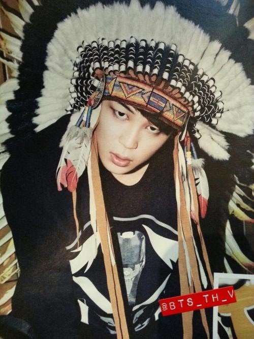 Jimin wears a Native American headdress