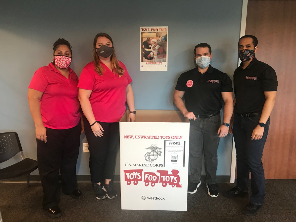 OMGTampaBay's tweet photo. Our physical therapy team, Ryan, Dennis, Brenna, and Sandra, rocking the new pink shirts for #breastcancerawareness with our @ToysForTots_USA bin. We just put it out for this year and are excited to see it fill up as the holidays get closer! https://t.co/DB6NhHSvCK
