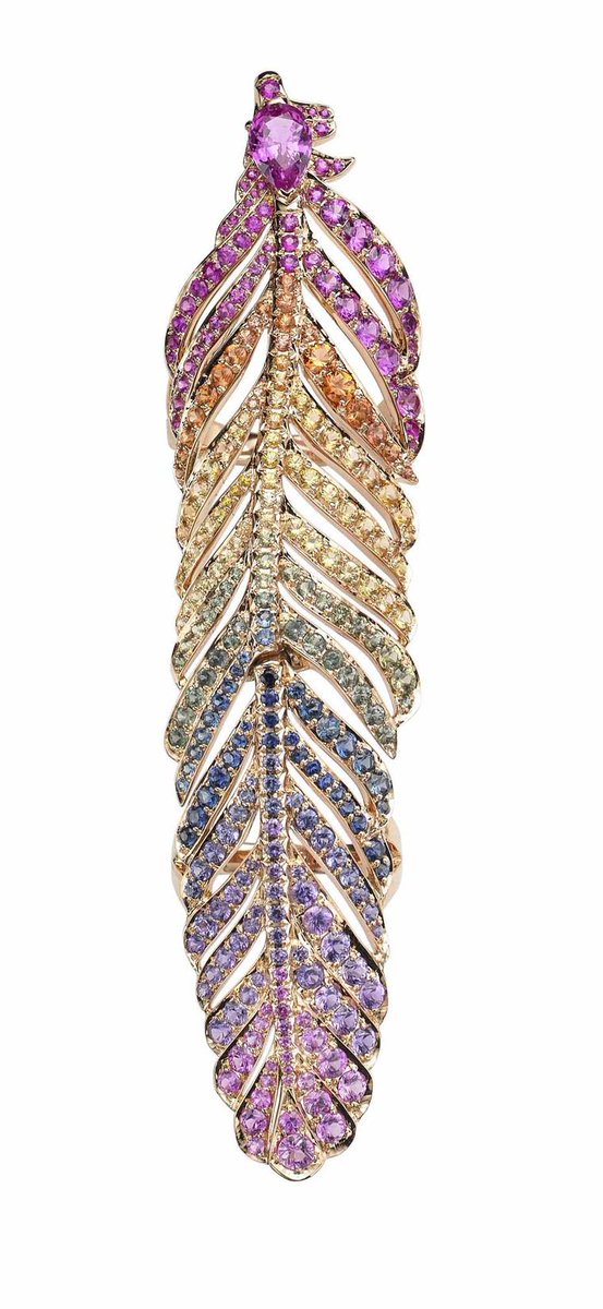 From Crow's Nest, a full-finger ring in the shape of a feather, mostly sapphires.