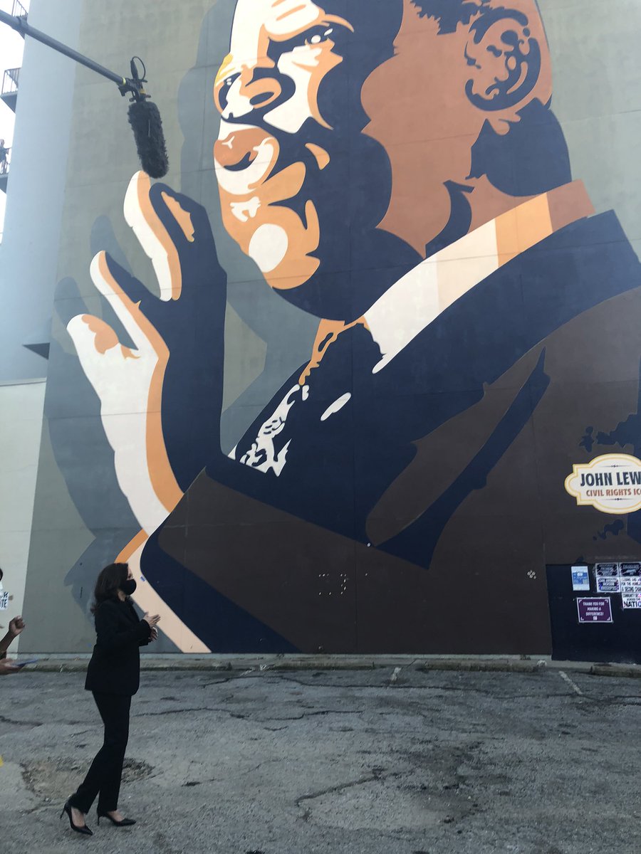 At her last stop of the day,  @KamalaHarris visited the towering mural of John Lewis in downtown Atlanta to honor the late civil rights hero’s legacy.  #gapol – bei  John Lewis Mural