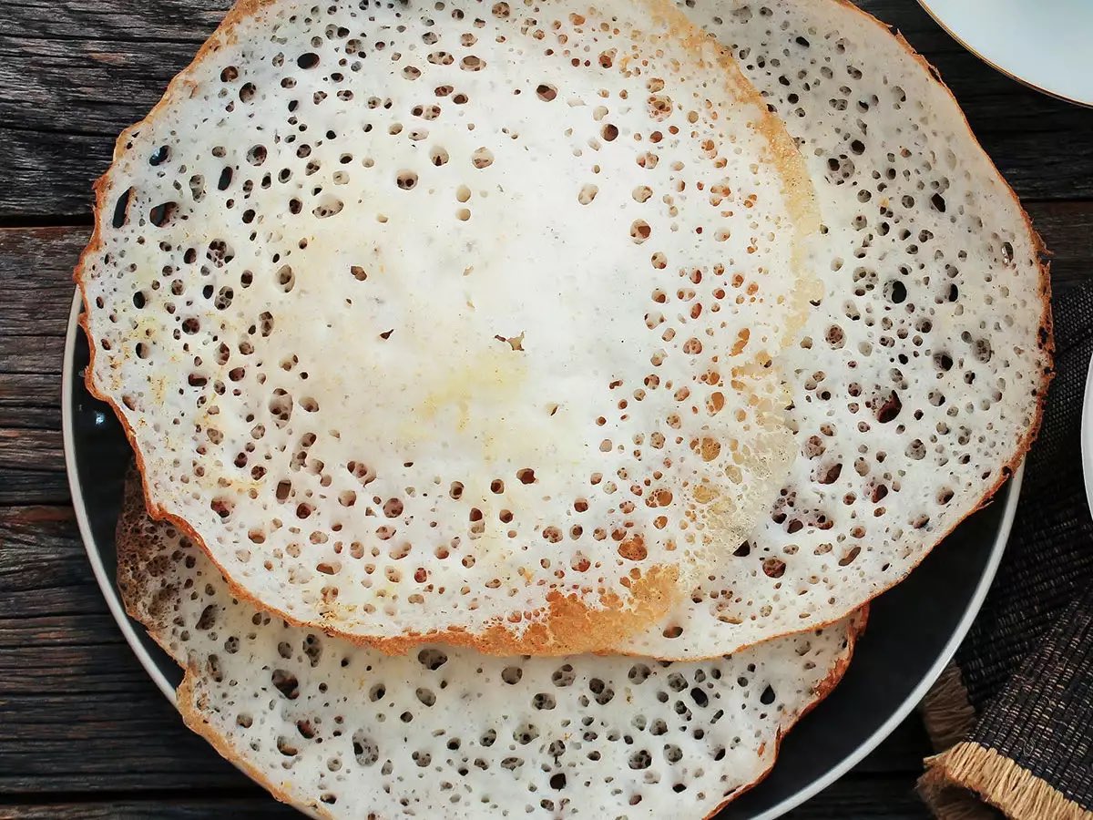 APPAM. Oh my favourite. It’s usually eaten with milk and red sugar. It’s amazing. Crispy on the outside, soft in the middle. Very popular among Tamils and Malayalees.