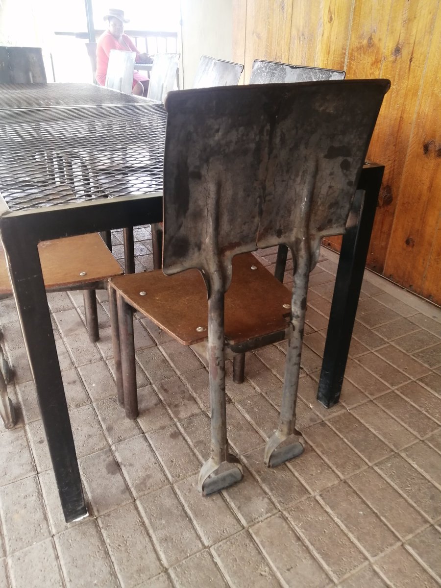 At the Tower of Pizza, and their chairs are made of garden shovels