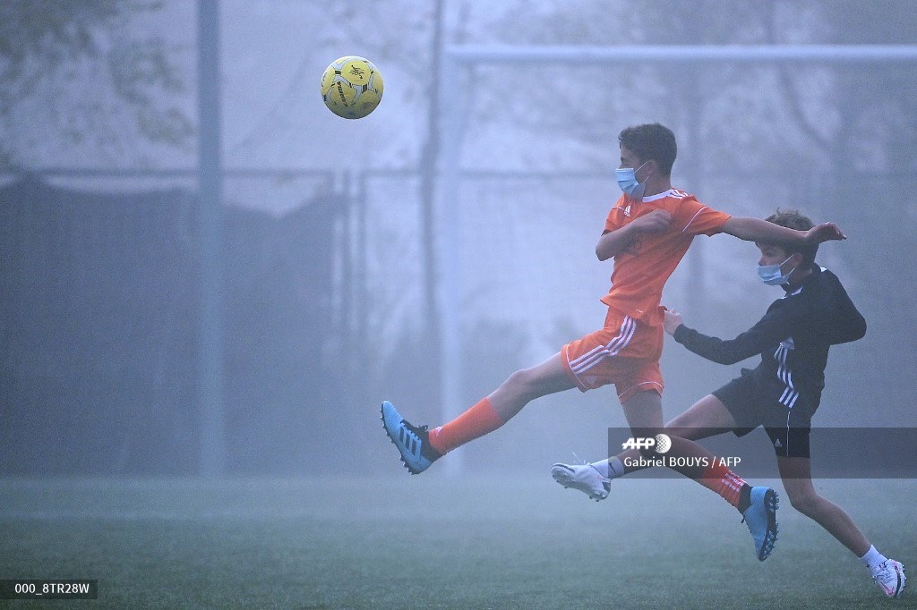 AFPphoto's tweet photo. #Spain Playing football with face masks during the coronavirus pandemic in Las Rozas, outside Madrid https://t.co/oXp5C4qm16