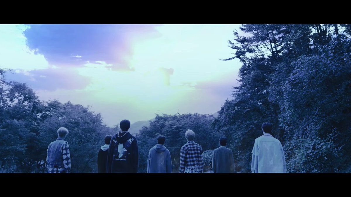 the screen fades to black & the music stops. like i said, the previous shot was a resolution, and ending. now, the color palette has compeltely shifted from dark greens to cold hues of blue. jungwon walks resolutely towards the rest of them, like a decision has been made,