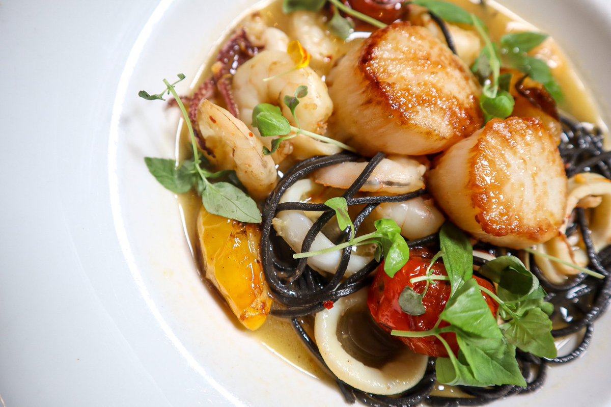 Our Squid Ink Pasta is protein packed and guilt free! Try it for #dinner tonight! (Scallops | Shrimp | Calamari | Blistered Tomatoes | Saffron Broth)