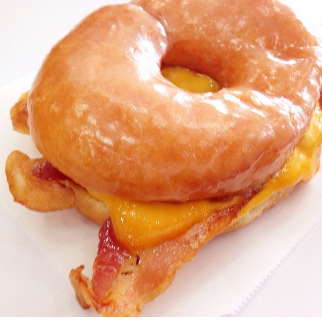 Pssssssst... Hey You... Yes You... Try our Breakfast Sandwich (Moist Doughnut, Warm Glaze, Fresh Bacon and Melted Cheese) #EatGlazed