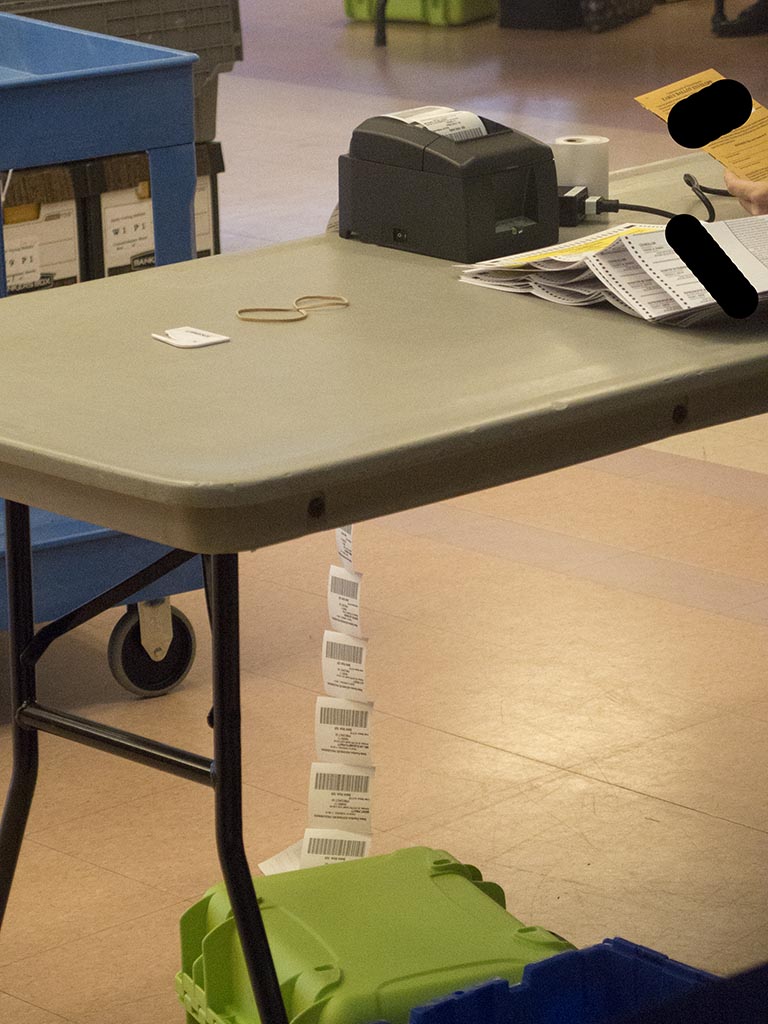 The iPads (also known as "PollPads") also print a "receipt" for each ballot checked in. Pictured here hanging off the table.I'm told that this is to facilitate a potential future audit. [It's not the most convenient format, but I'm not sure what all the equities are.]