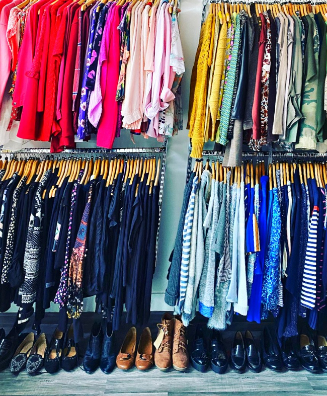 Image of colourful clothes on a rack at Vista's Rothley charity shop.