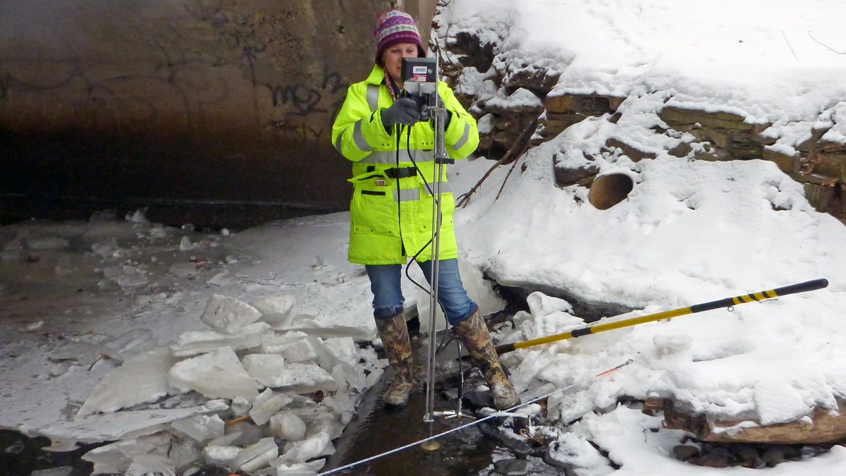 U.S. Geological Survey hydrologic technician Katie Allenson measures streamflow through ice on Minnehaha Creek in Minneapolis, Minnesota. (U.S. Geological Survey. Public domain.) 