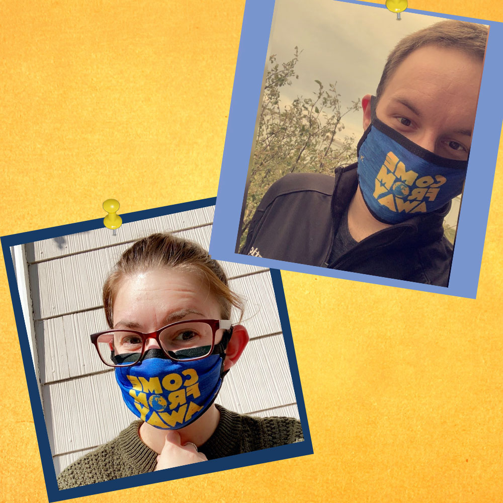 two fans in Come From Away face masks