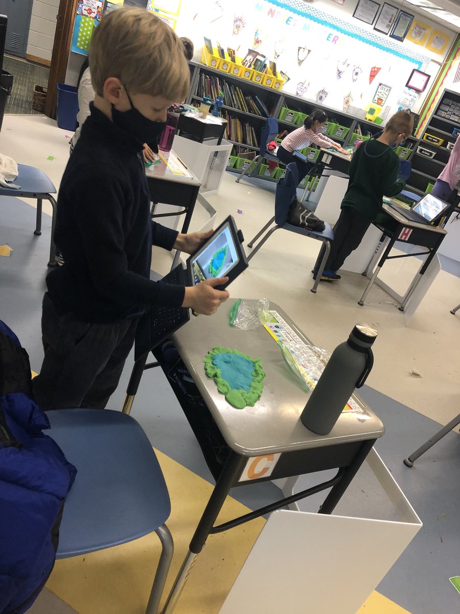 Designing landforms and waterforms with playdough while documenting their creation using Seesaw.