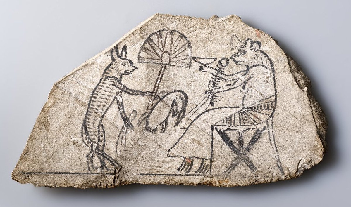 A caricature, an animal fable, a satire of the royal family or just for fun? 
c. 3,200 years ago, this fascinating scene, depicting a cat servant, waving a fan to keep a mouse cool, was drawn with black ink on a limestone ostracon, by an ancient Egyptian.