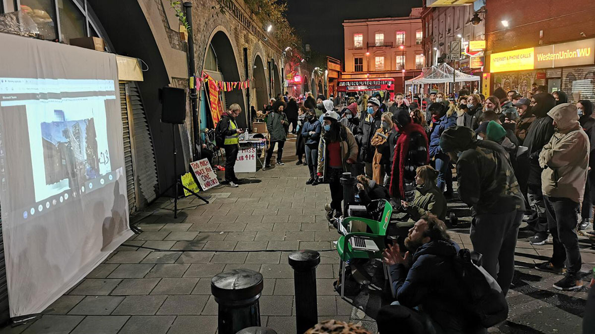 NoHondoTower's tweet photo. #Brixton community members gathered in Brixton Station Road to watch a live-screening of the @Lambeth_Council Planning Applications Committee meeting on 3 November #NoHondoTower @Save_Nour #FightTheTower https://t.co/HCww2k3VKL